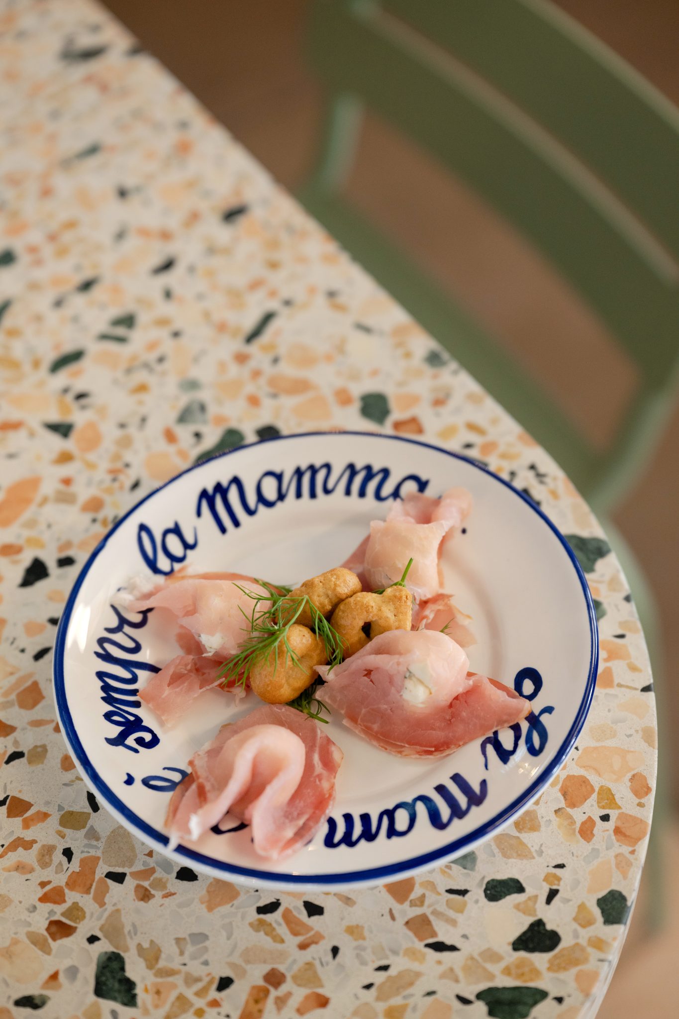 Assiette de charcuterie sur table en terrazzo.